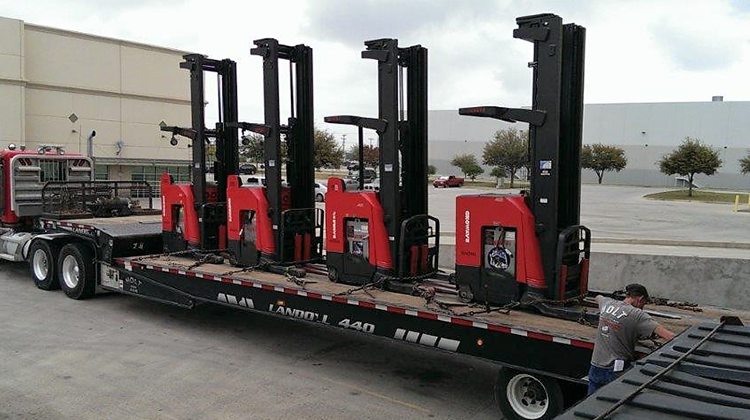 Forklifts Being Loaded Onto Flatbed Truck 